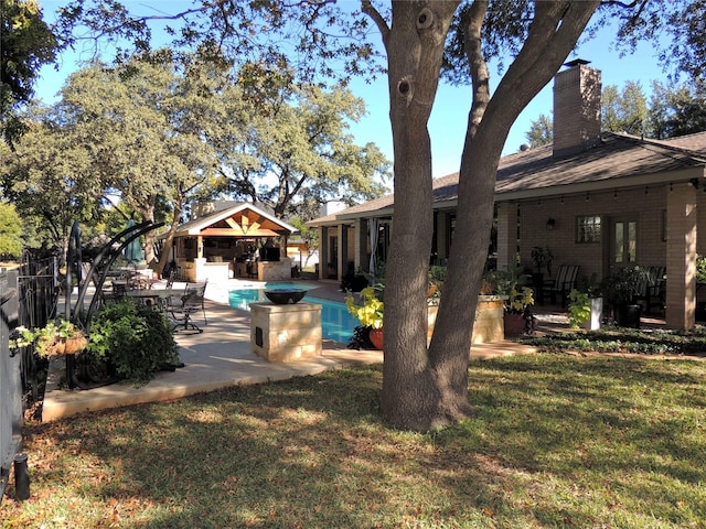 view of yard featuring an outbuilding and a patio area