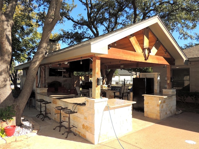 view of patio / terrace with a gazebo and an outdoor bar