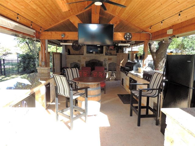 view of patio / terrace featuring area for grilling, a gazebo, an outdoor bar, and ceiling fan