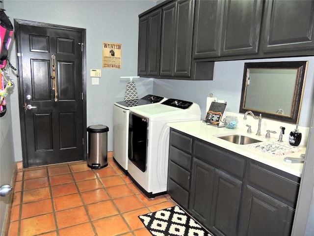 clothes washing area featuring cabinets, light tile patterned flooring, sink, and washer and clothes dryer