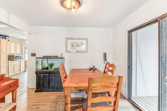 dining area featuring light wood-type flooring