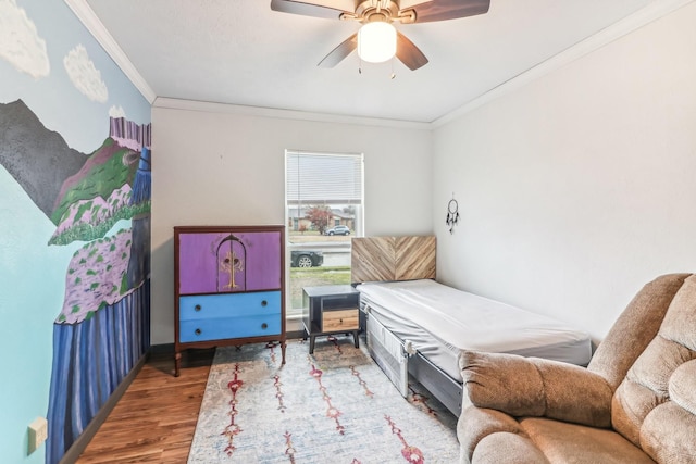 bedroom featuring hardwood / wood-style flooring, ceiling fan, and ornamental molding