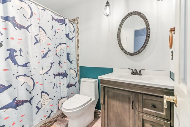 bathroom with walk in shower, hardwood / wood-style flooring, vanity, and toilet