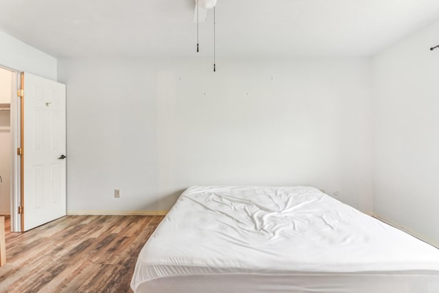 bedroom featuring hardwood / wood-style floors and ceiling fan