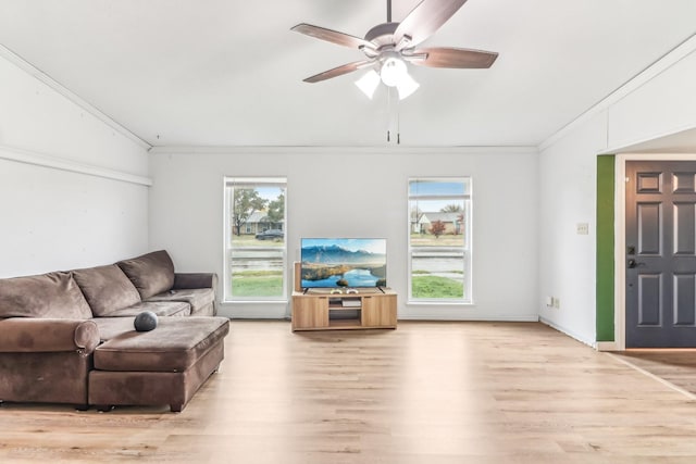 living room with ceiling fan, wood-type flooring, and ornamental molding