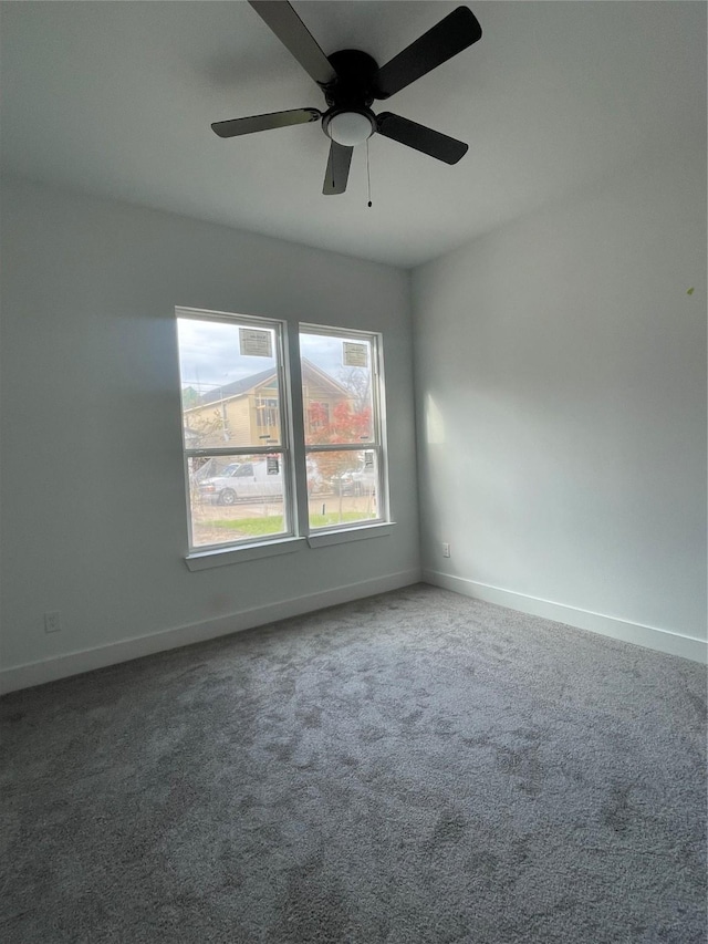 carpeted empty room featuring ceiling fan