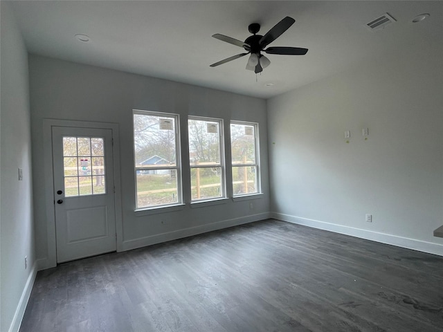 unfurnished room with dark hardwood / wood-style flooring and ceiling fan