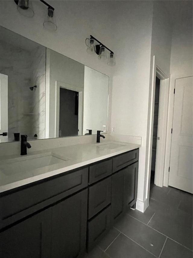 bathroom featuring tile patterned floors, vanity, and tiled shower