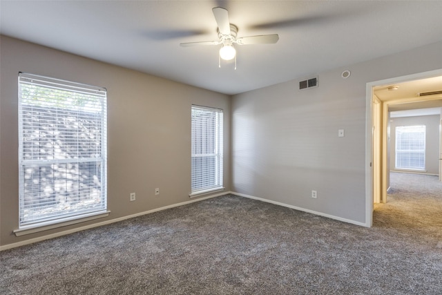 carpeted spare room featuring ceiling fan