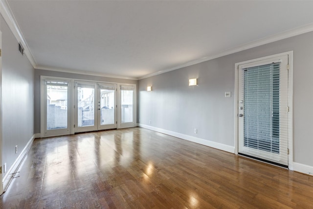 empty room with hardwood / wood-style floors and ornamental molding