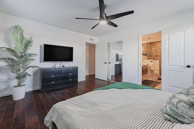 bedroom with connected bathroom, ceiling fan, and dark wood-type flooring