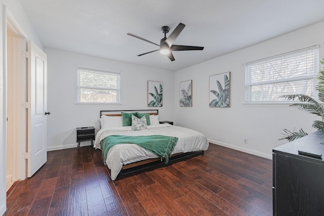 bedroom featuring ceiling fan and dark wood-type flooring