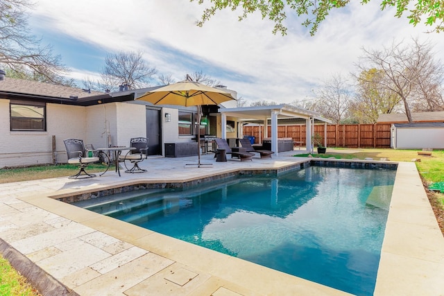 view of pool featuring outdoor lounge area, a storage shed, and a patio