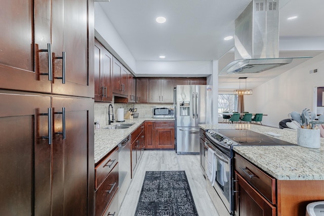 kitchen with sink, light hardwood / wood-style flooring, light stone countertops, range hood, and stainless steel appliances