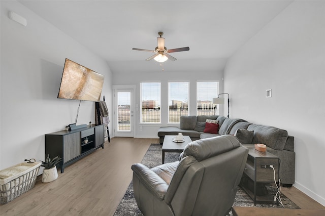 living room with ceiling fan, lofted ceiling, and hardwood / wood-style flooring