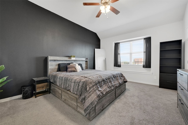 carpeted bedroom with ceiling fan and vaulted ceiling