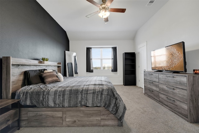 bedroom with light colored carpet, ceiling fan, and lofted ceiling