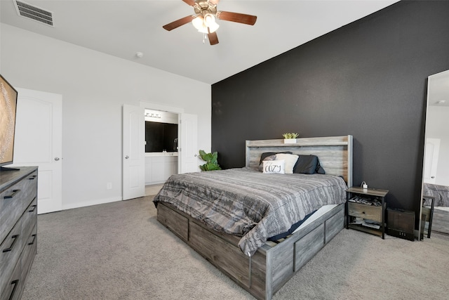 bedroom with light carpet, ensuite bath, ceiling fan, and lofted ceiling