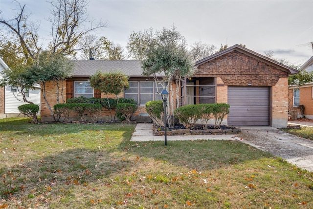 ranch-style house featuring a garage and a front lawn