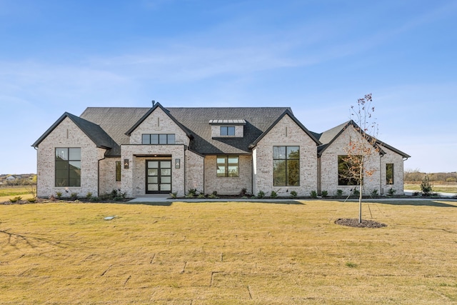 view of front facade with french doors and a front lawn