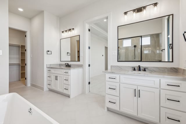 bathroom featuring tile patterned floors, vanity, and shower with separate bathtub