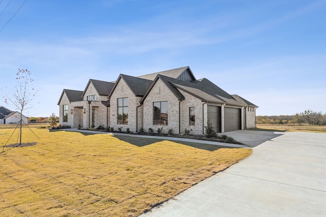 view of front of property with a garage and a front lawn