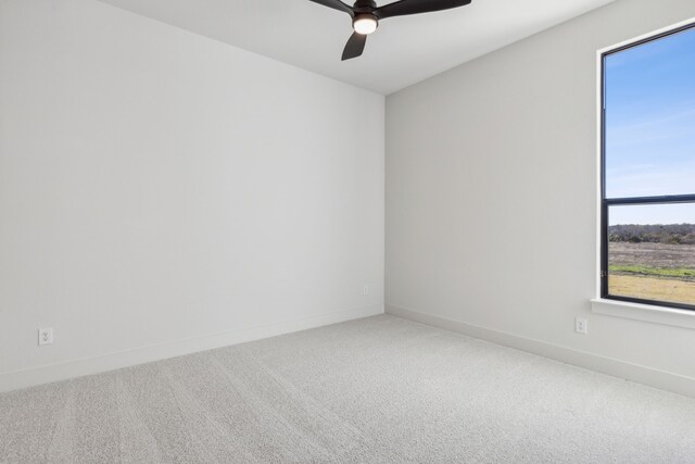 spare room with carpet flooring and ceiling fan