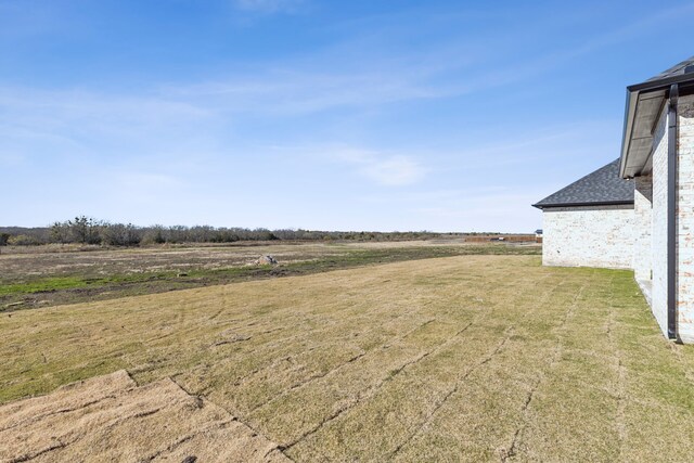 view of yard with a rural view