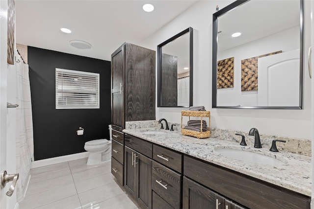 bathroom with tile patterned flooring, vanity, and toilet