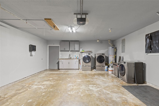 garage featuring electric panel, a garage door opener, gas water heater, sink, and washing machine and dryer