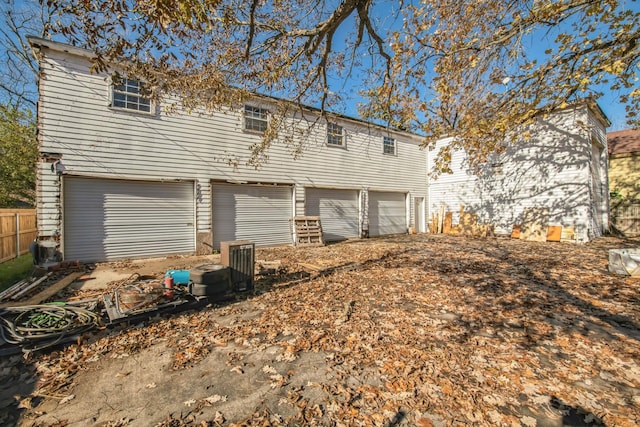 rear view of property with a garage