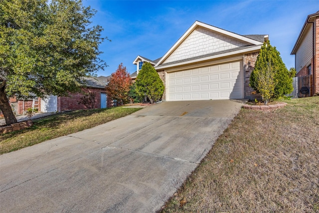 view of front of property featuring a front yard and a garage