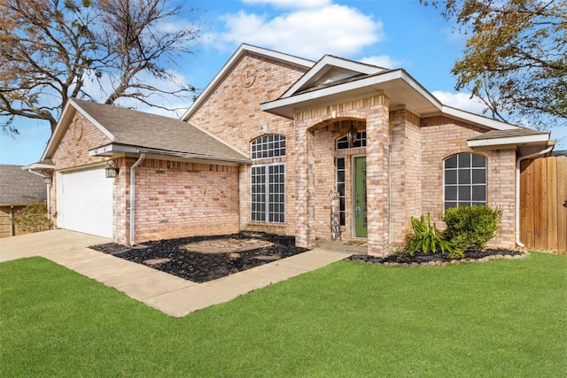 view of front of home with a garage and a front lawn