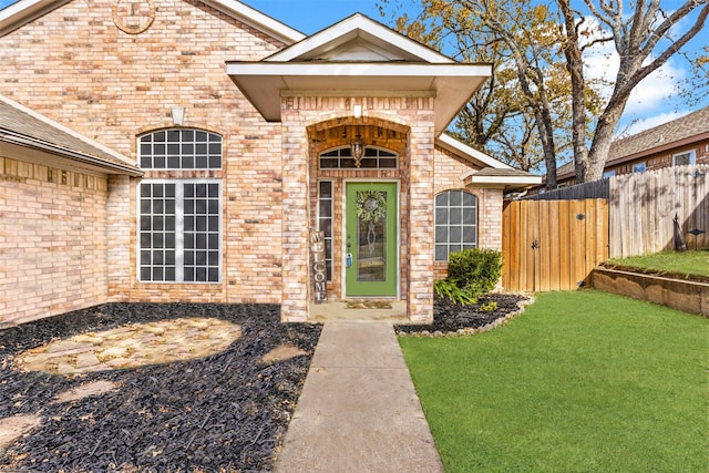 doorway to property featuring a yard