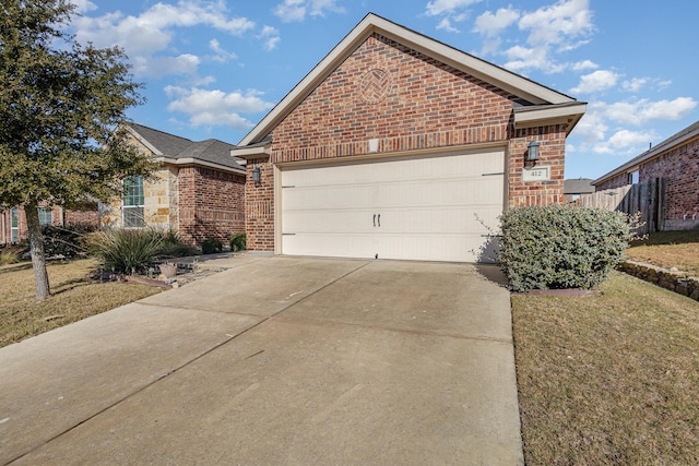 view of front of property with a garage and a front lawn