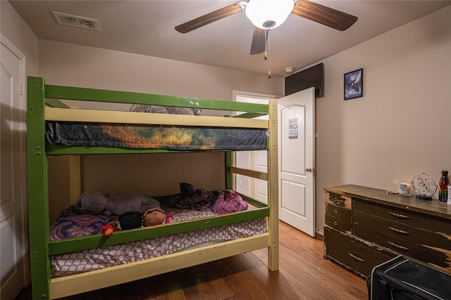 bedroom with light hardwood / wood-style floors and ceiling fan