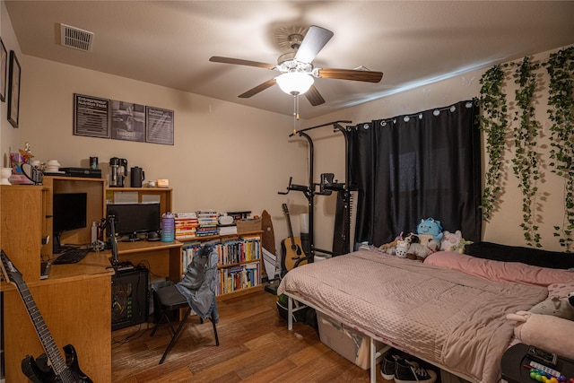 bedroom featuring hardwood / wood-style flooring and ceiling fan