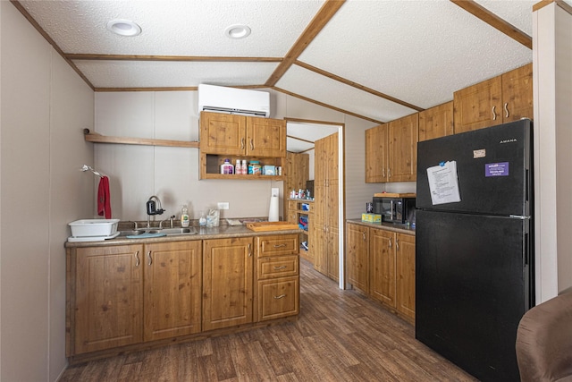 kitchen with sink, dark hardwood / wood-style floors, a textured ceiling, lofted ceiling, and black appliances