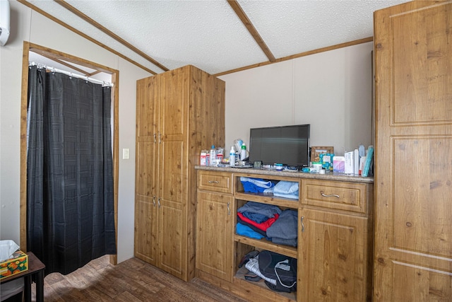 home office featuring a wall mounted AC, crown molding, dark wood-type flooring, and a textured ceiling