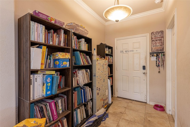 tiled entrance foyer featuring crown molding