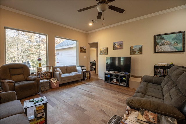 living room with light hardwood / wood-style floors, ceiling fan, and crown molding