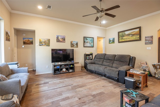 living room with ceiling fan, light wood-type flooring, and crown molding