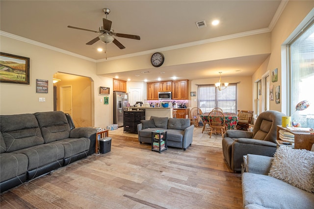 living room with crown molding, light hardwood / wood-style flooring, and ceiling fan with notable chandelier