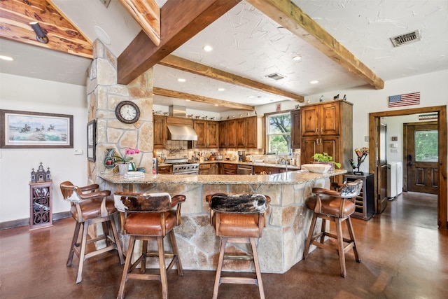 kitchen with ventilation hood, appliances with stainless steel finishes, beam ceiling, kitchen peninsula, and beverage cooler