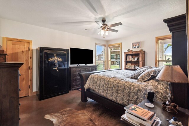 bedroom with ceiling fan, a textured ceiling, and multiple windows