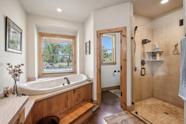 bathroom featuring shower with separate bathtub