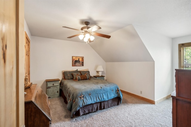 carpeted bedroom with ceiling fan, a closet, and lofted ceiling