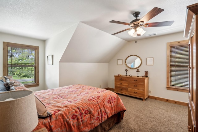 bedroom with ceiling fan, light colored carpet, a textured ceiling, and vaulted ceiling