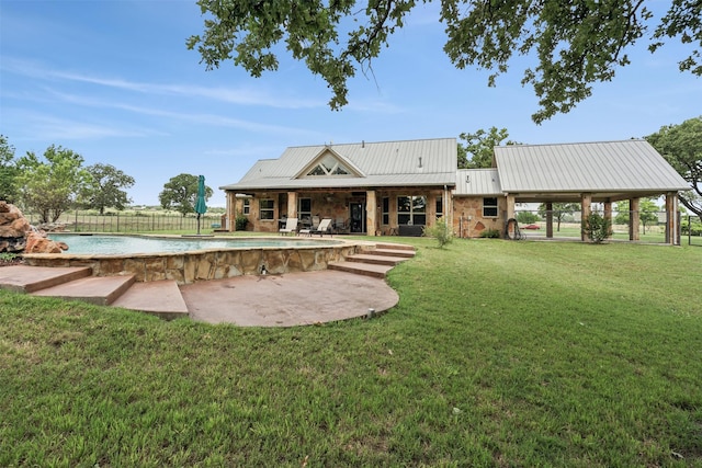 rear view of house with a yard and a patio