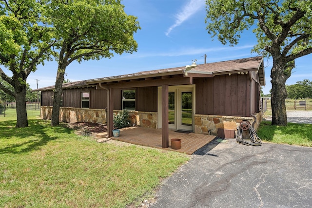 rear view of property with a yard and a patio area